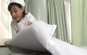 Sexy japanese nurse giving the actuality a handjob