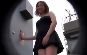 Asian teen can't do anything against the wind go off at a tangent lifts her clothes up !