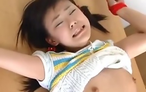Cute Japanese legal age teenager was bound on a table and made to cum.